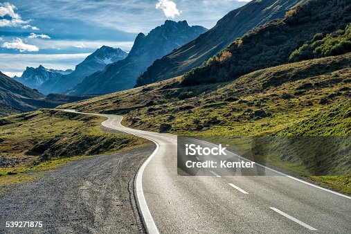 istock winding mountain road without cars 539271875