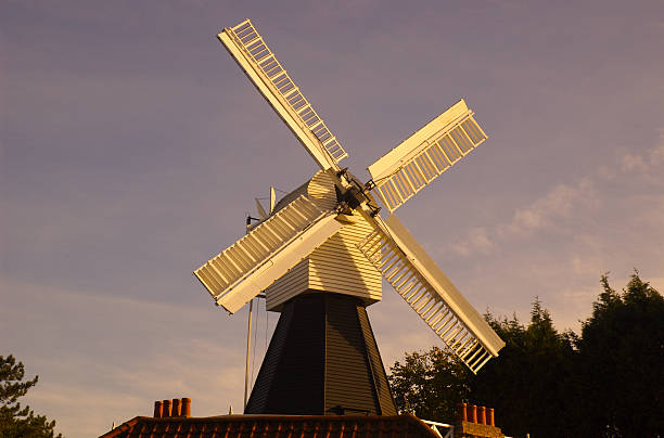 Windmill at sunrise stock photo