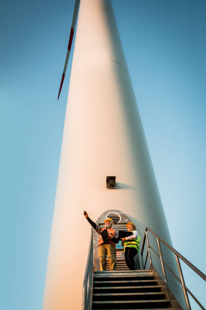 Windmill engineers inspection and progress check wind turbine stock photo