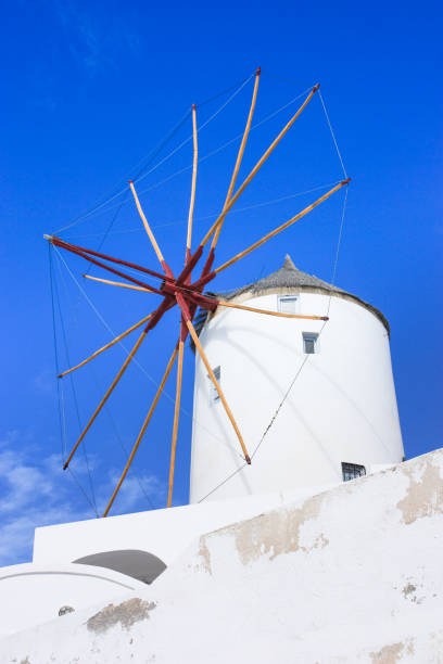 Windmill house in Oia with blue sky, Santorini stock photo