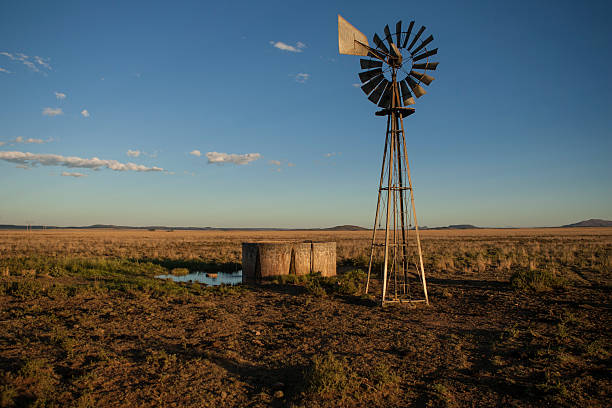 Windmill on arid farm in South Africa stock photo