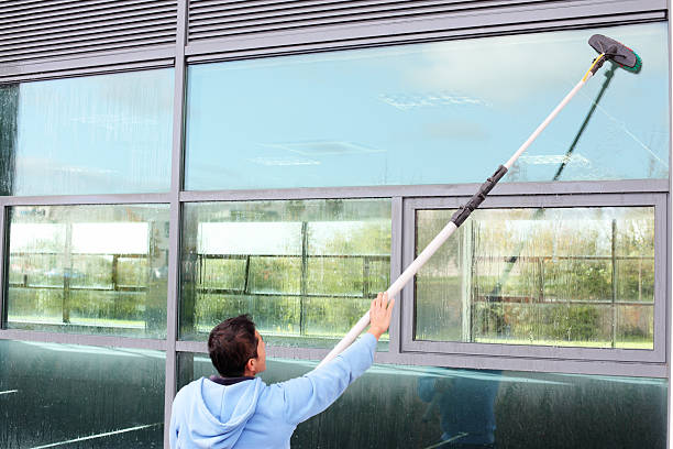 Window cleaner using the water fed pole system Window cleaner using the water fed pole system, also called reach and wash. window cleaning stock pictures, royalty-free photos & images
