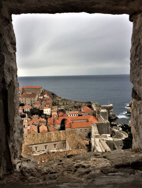 Window framing view of Old Town Dubrovnik and the Adriatic Sea stock photo