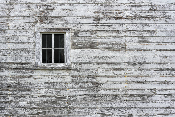 Window on weathered old peeling white wall stock photo