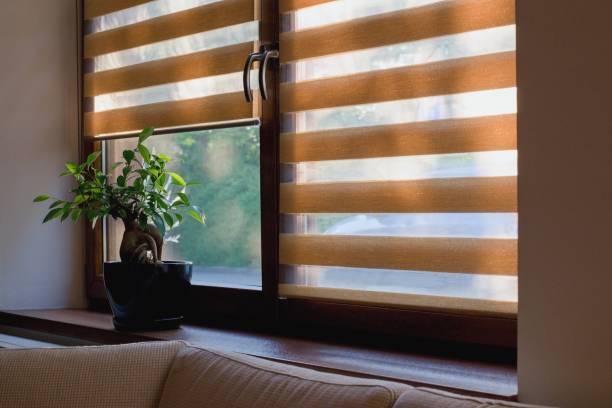 Window roller, duo system day and night. Morning light shining through the window. Window roller, duo system day and night. Morning sunlight shining through the window. roller blinds stock pictures, royalty-free photos & images