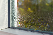 istock window with water drops closeup, inside, selective focus 871142028