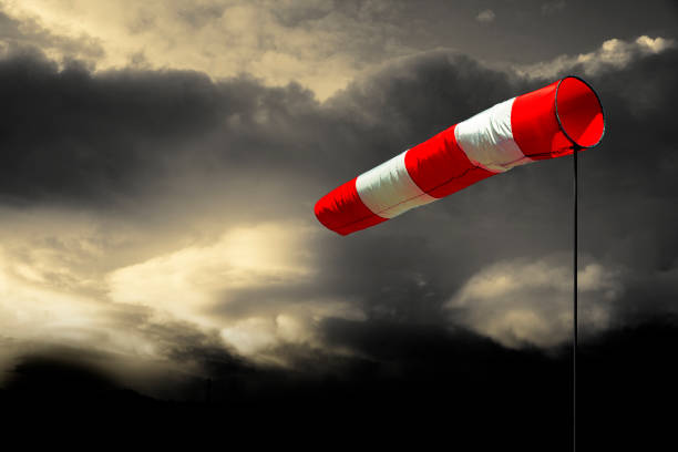 Windsock with Cloudy Sky Windsock with Cloudy Sky storm stock pictures, royalty-free photos & images