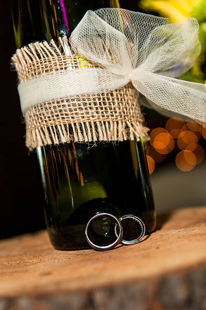 Wine bottle and wedding rings stock photo