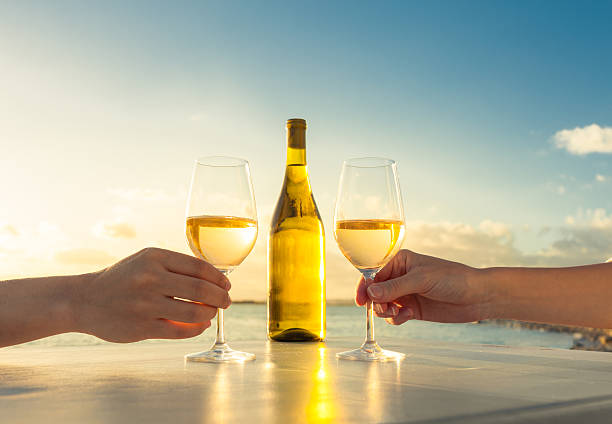 wine by the sea - sunset dining stockfoto's en -beelden