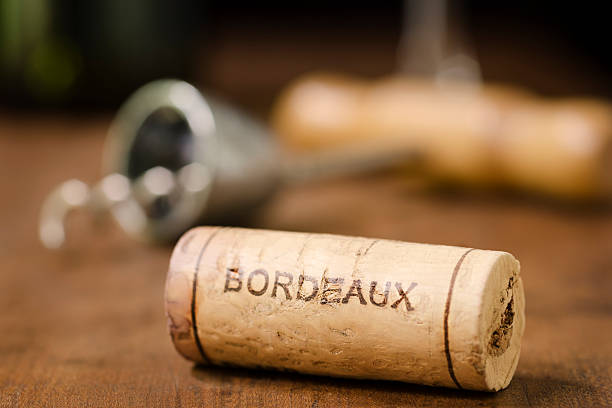 Wine Cork from Bordeaux France Horizontal "A wine cork from Bordeaux France with a corkscrew, wine glass, and wine bottle in the background." bordeaux photos stock pictures, royalty-free photos & images