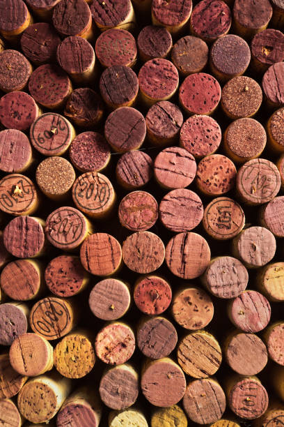 Wine Cork Stoppers with Various Vintages A collection of various vintages of wine corks background texture cork stopper stock pictures, royalty-free photos & images