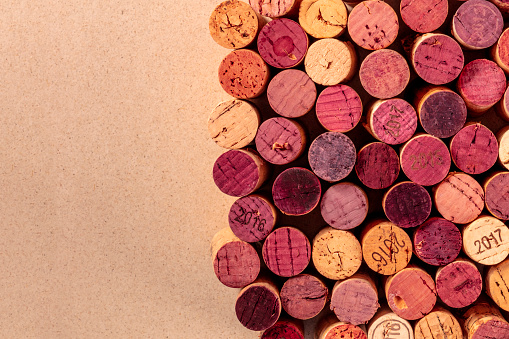 Wine corks background texture, a design template for a restaurant banner or tasting invitation, overhead shot with copy space