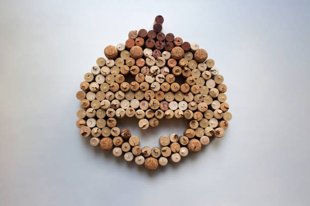 Wine corks Halloween pumpkin Wine corks Halloween pumpkin abstract composition isolated on white background from a high angle view cork stopper stock pictures, royalty-free photos & images