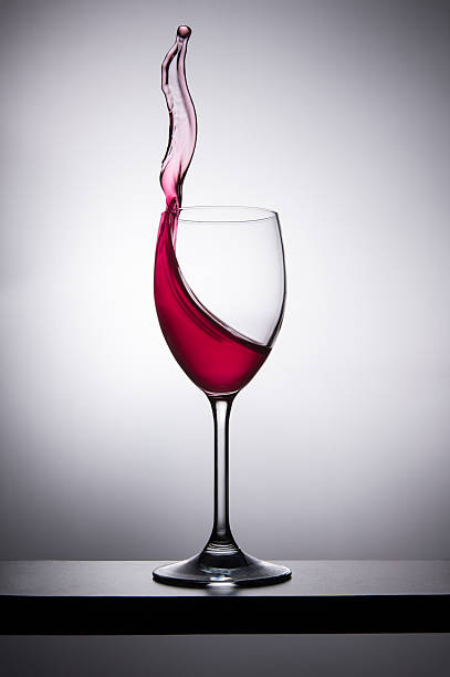 wine glass that creates a splash that comes out stock photo