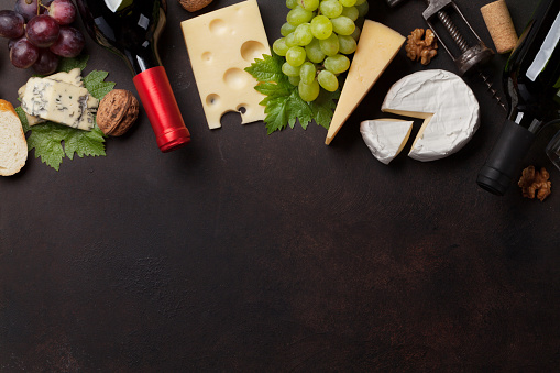 Wine, grape, nuts, bread and cheese. Top view with space for your text
