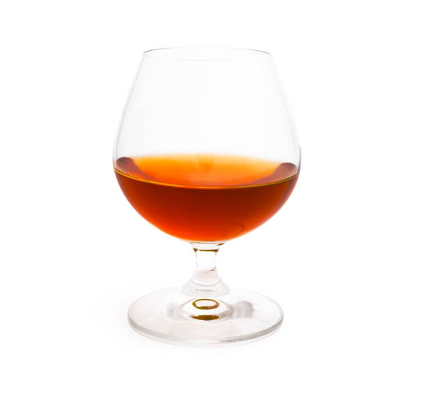 Wineglass with cognac isolated on white background Wineglass with cognac or brandy isolated on white background calvados stock pictures, royalty-free photos & images