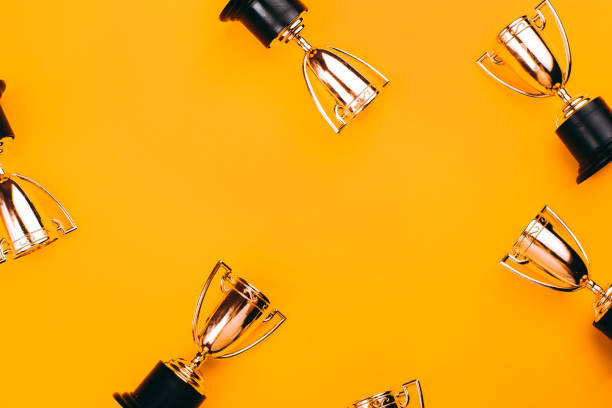 Winner or champion cup. Winner or champion cup on bright background, Flat lay style. Open composition. trophy award stock pictures, royalty-free photos & images