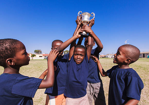 Winning team lifting trophy, Gugulethu, Cape Town, South Africa stock photo