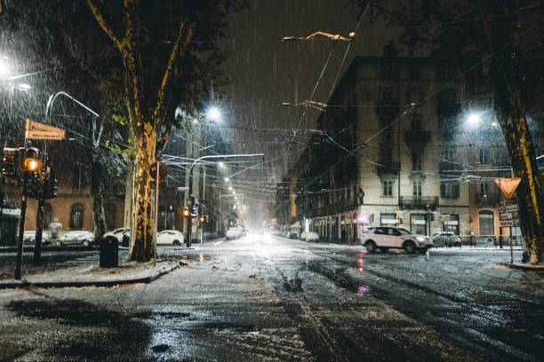 Winter city street in the night under the snow Turin Italy stock photo