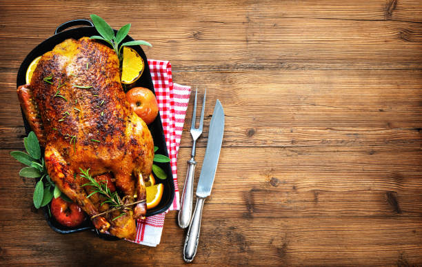 Winter Holiday table served for Christmas dinner Winter Holiday table served for Christmas dinner with roasted duck duck meat photos stock pictures, royalty-free photos & images