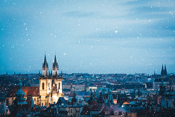 Winter In Prague Illuminated Týn church in Prague (Czech Republic) on a snowy Christams evening. prague old town square stock pictures, royalty-free photos & images