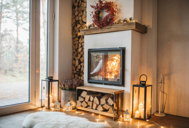 Winter is here Cozy living room winter interior with fireplace firewood stock pictures, royalty-free photos & images