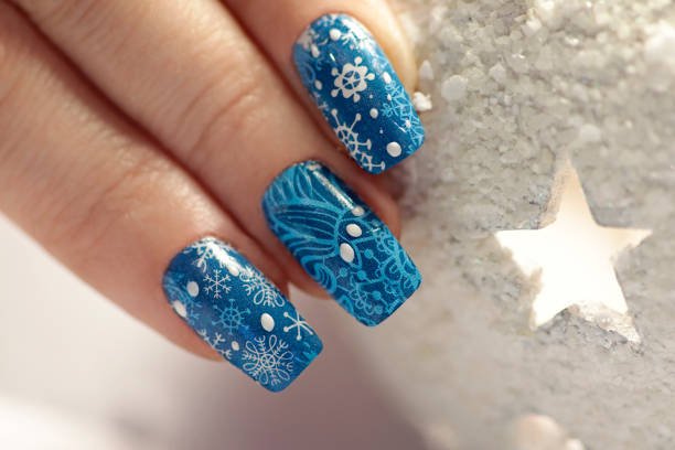 Winter manicure with nail stickers stock photo