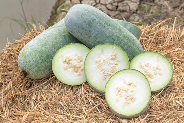 Winter melon is cut into pieces on the straw. stock photo