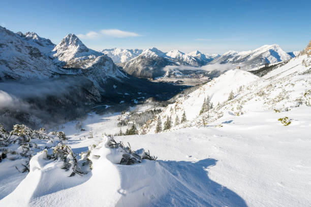 Winter panorama of the Ehrwald basin, Ehrwalder Sonnenspitze, Wetterstein massif, Ammergau and Lechtal Alps from the Mount Issentalkopf, Austria stock photo
