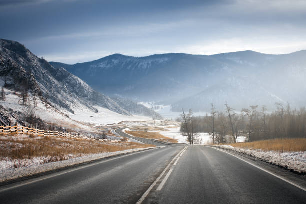 Winter road on mountains. Sunny weather. stock photo