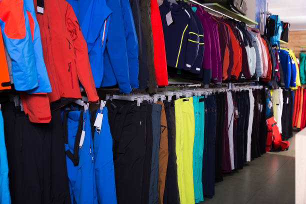 Variety of winter sport clothing for skiing on hangers in shop