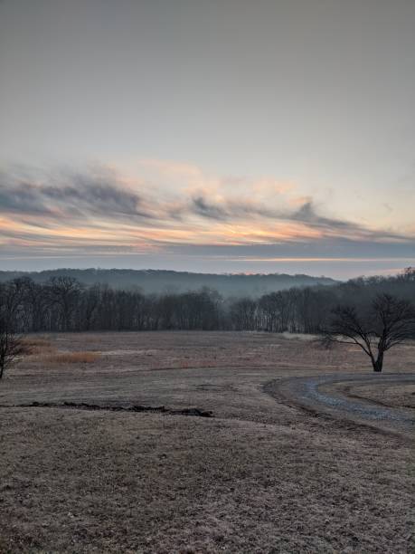 Winter sunrise over an open field stock photo