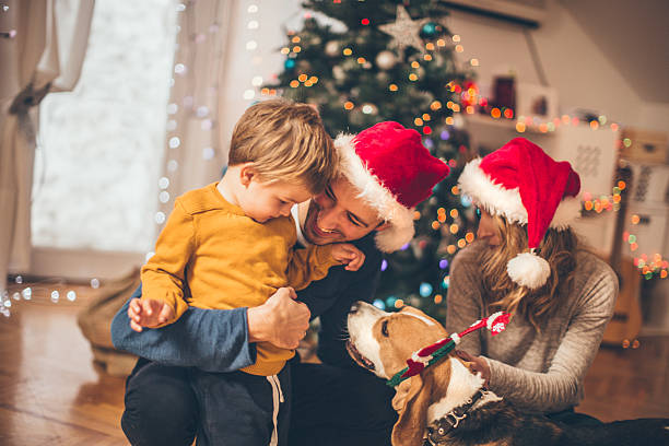 Winter time and family love Little boy spending time enjoying with his family on Christmas morning happy new year dog stock pictures, royalty-free photos & images
