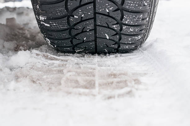 Winter tyre on the road stock photo