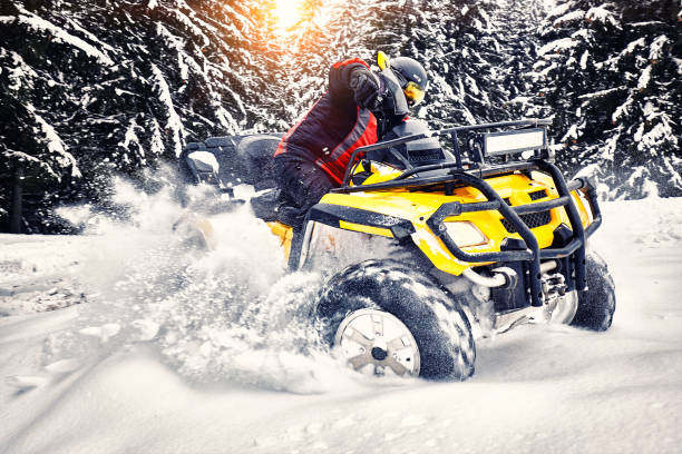 Winter walk on the quad bike in the forest. stock photo