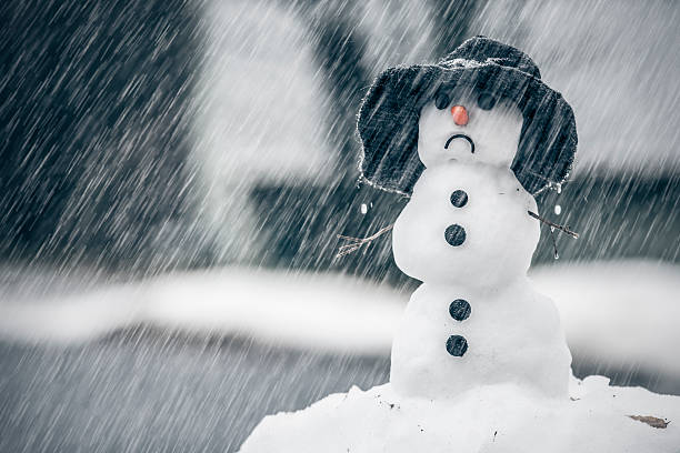 Winter weather anomalies Melting snowman on the warm rainy day in the middle of January winter weather anomalies. melting snow man stock pictures, royalty-free photos & images