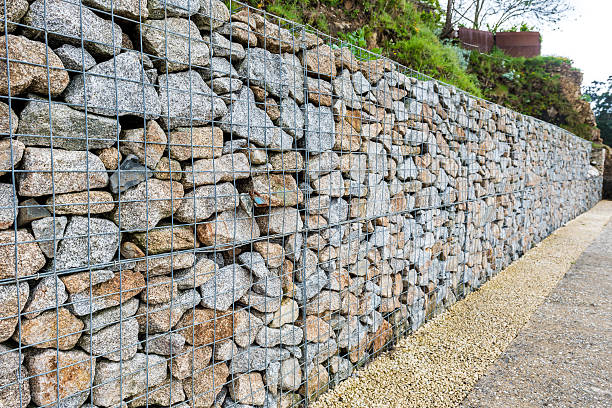 Wire Gabion Rock Fence. Metal Cage filled with rocks. stock photo