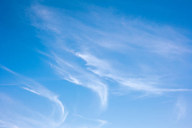 Wispy cirrus clouds on a clear day Cirrus cloudscape on a bright sunny day and blue sky. cirrostratus stock pictures, royalty-free photos & images