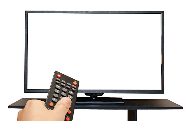 TV with blank screen and hand holding Remote Control isolated stock photo
