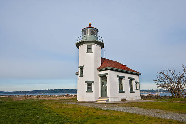Point Robinson Lighthouse With the advent of radar, GPS and other advanced navigation tools, lighthouses no longer need to perform the same function they once did; guiding ships to safety. Instead they have been preserved as historic monuments; reminding us of a time when shipping and sailing were more perilous activities. The Point Robinson Lighthouse is located on Vashon Island, Washington State, USA. jeff goulden lighthouse stock pictures, royalty-free photos & images