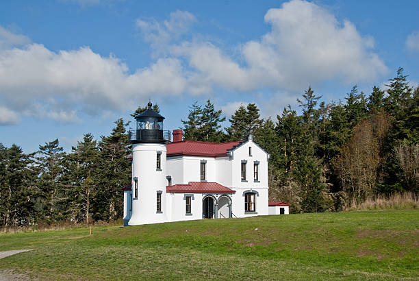 Admiralty Head Lighthouse With the advent of radar, GPS and other advanced navigation tools, lighthouses no longer need to perform the same function they once did; guiding ships to safety. Instead they have been preserved as historic monuments; reminding us of a time when shipping and sailing were more perilous activities. The Admiralty Head Lighthouse is located at Fort Casey State Park on Whidbey Island, Washington State, USA. jeff goulden puget sound stock pictures, royalty-free photos & images