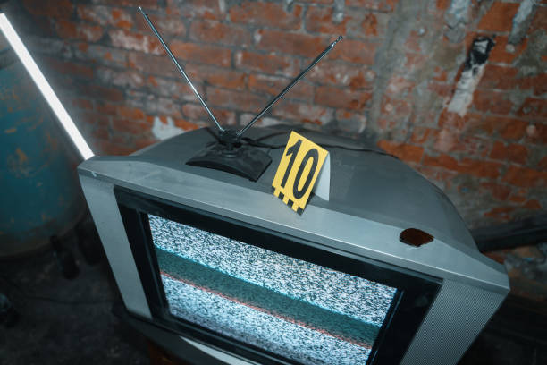 TV with Tv noise with yellow criminologist's number on it stock photo