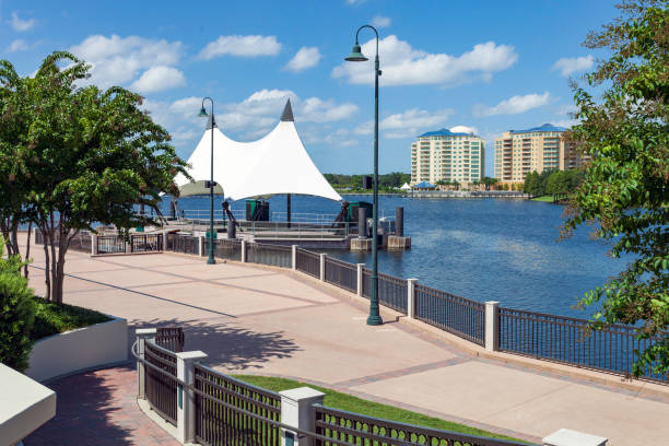 Within the 45-acre Cranes Roost park in the city of Altamonte Springs Florida these is a Floating Stage on a lake that's encircled by a one mile continuous walkway with benches along the way and some covered seating areas. stock photo