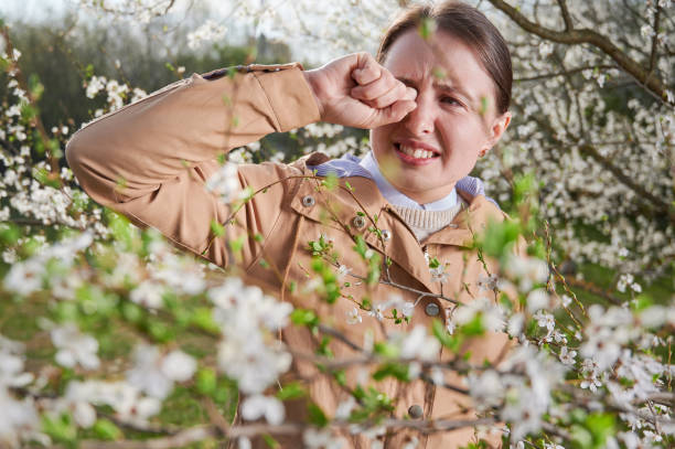 Woman allergic suffering from seasonal allergy at spring. stock photo