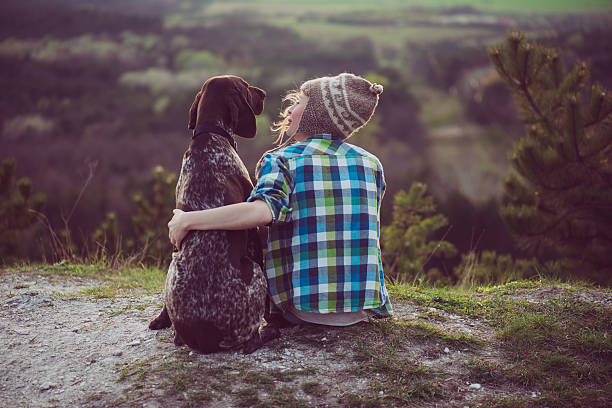 Woman and her dog posing outdoor. stock photo