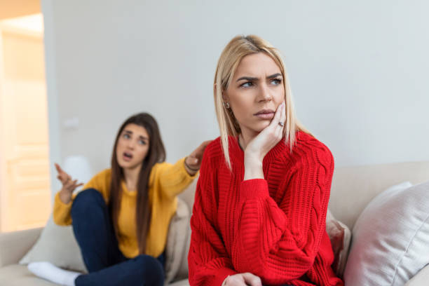 Woman apologizes to her friend after fight. Repentant woman hope for forgiveness from sad pensive friend. Family on verge of divorce. Couple treason problem concept stock photo
