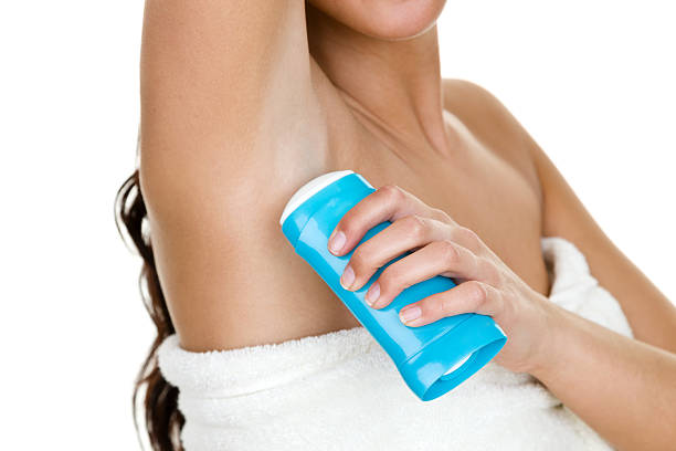 Woman applying deodorant stock photo
