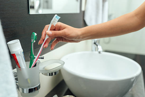 woman arm takes a toothbrush stock photo