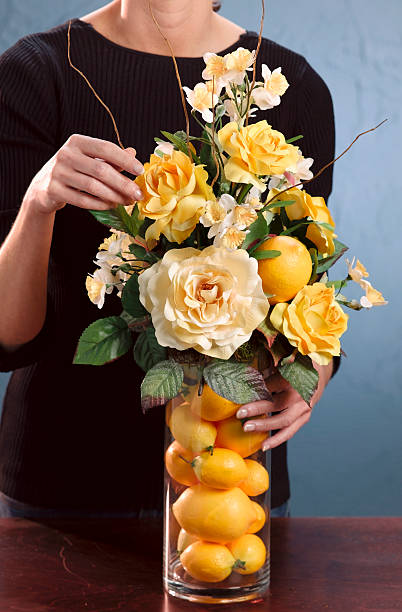 woman arranging flowers stock photo