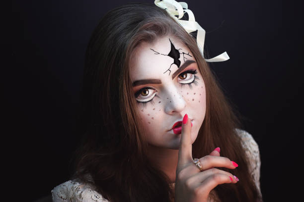 woman art make up creative Beautiful girl with creative make-up for the Halloween party. Bright colors faceart, pink lips, stylish hair dress design. Conceptual art broken porcelain doll with big cracks on the cheeks, forehead broken doll 1 stock pictures, royalty-free photos & images